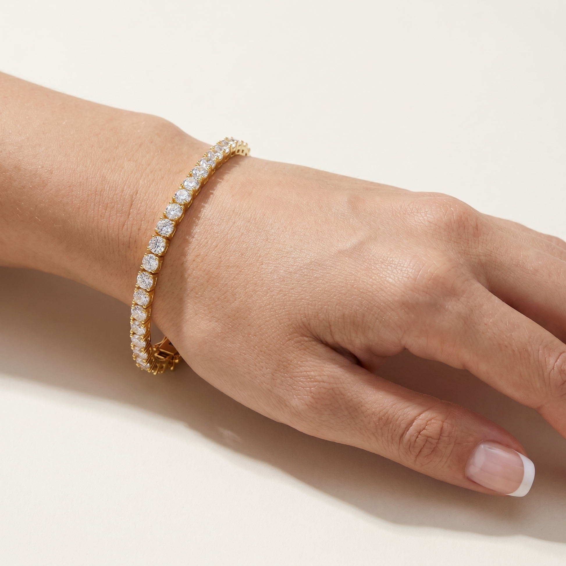 Gold plated tennis bracelet worn on wrist showing sparkle and fit