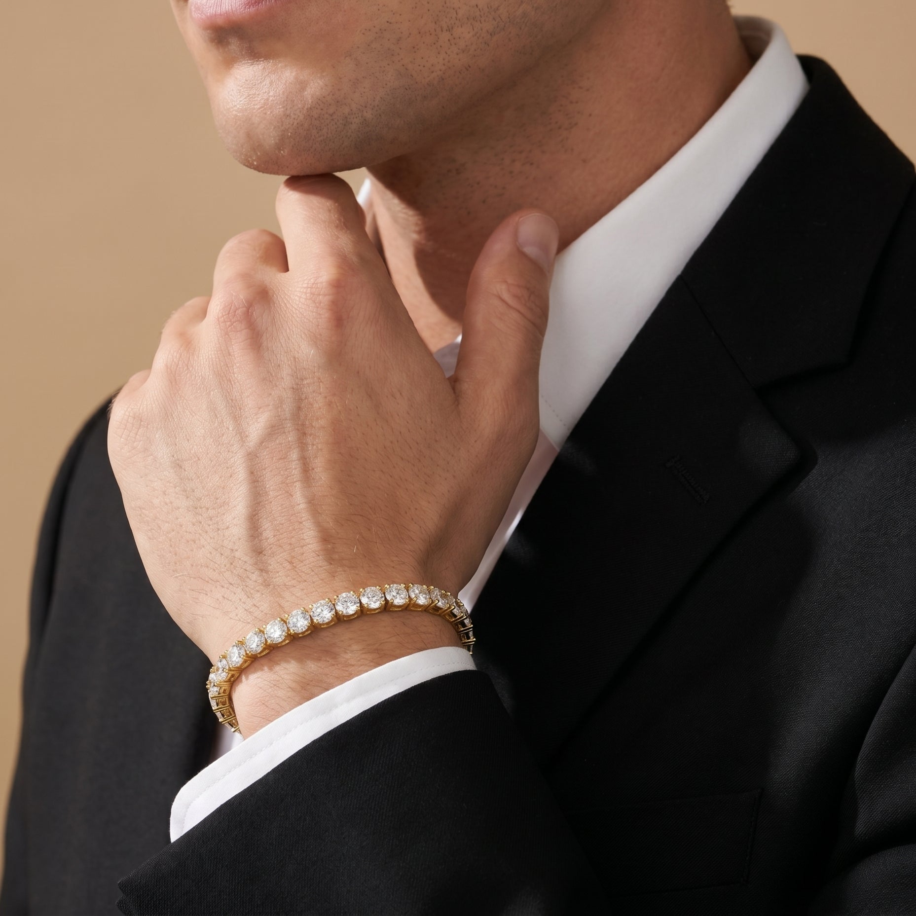 Luxury men's gold tennis bracelet styled with black suit and white shirt